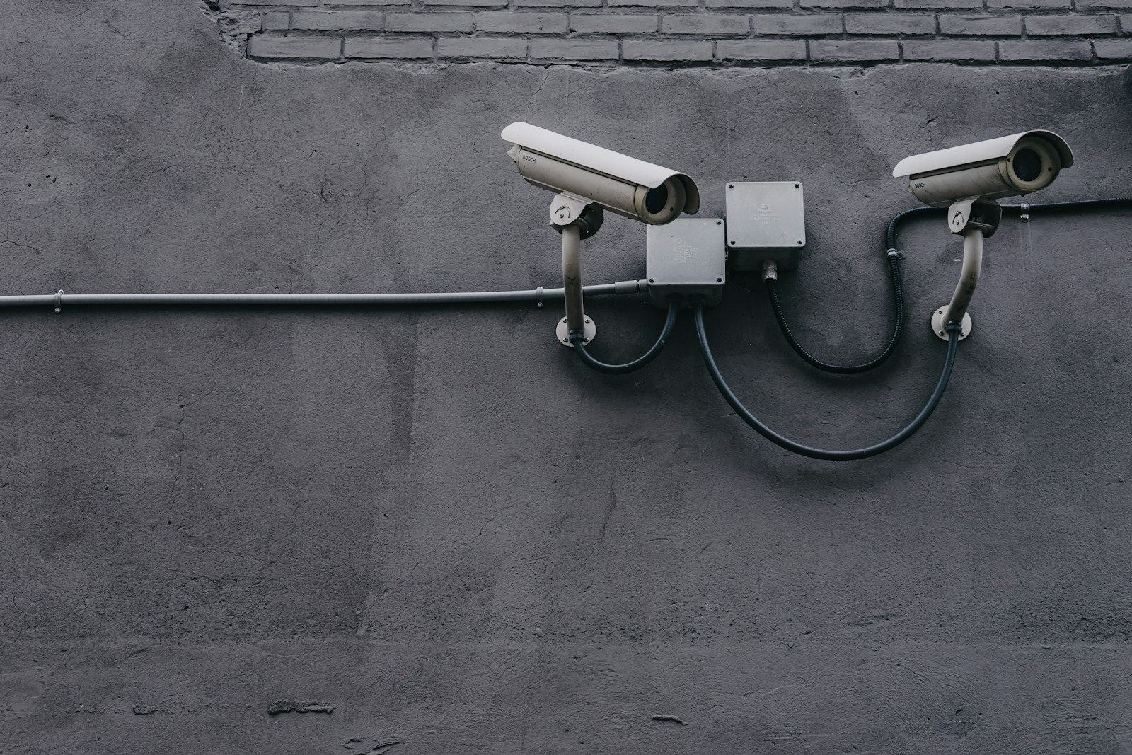 Two bullet cameras on a wall — stock photograph