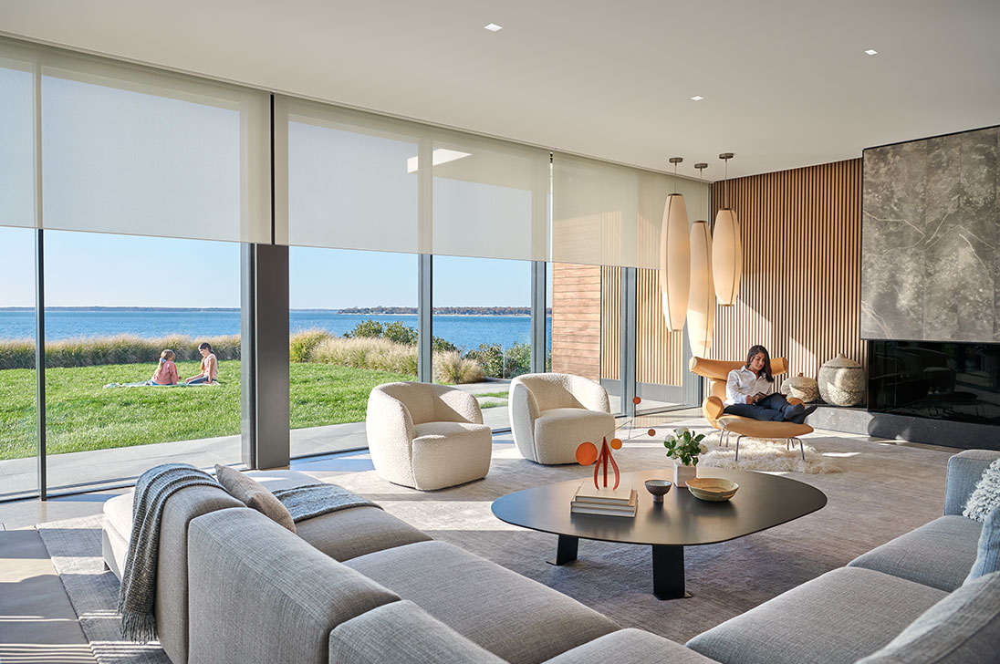 Coastal living room with window shades and natural light — from Lutron’s image gallery