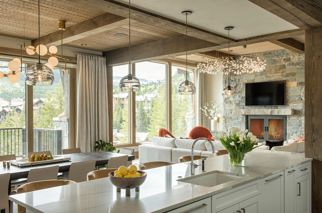 Living space with natural materials, pendant lighting and tall windows — from Lutron’s image gallery
